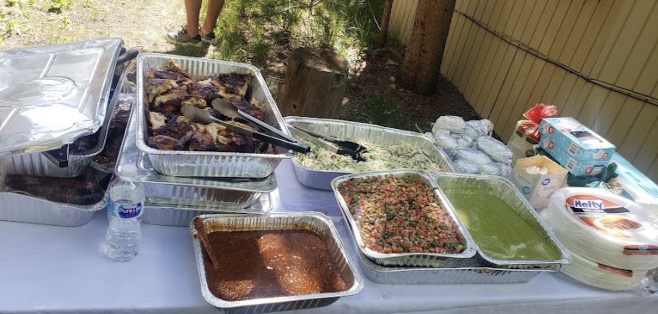 Porkys catering spread with chicken, salsas and sides